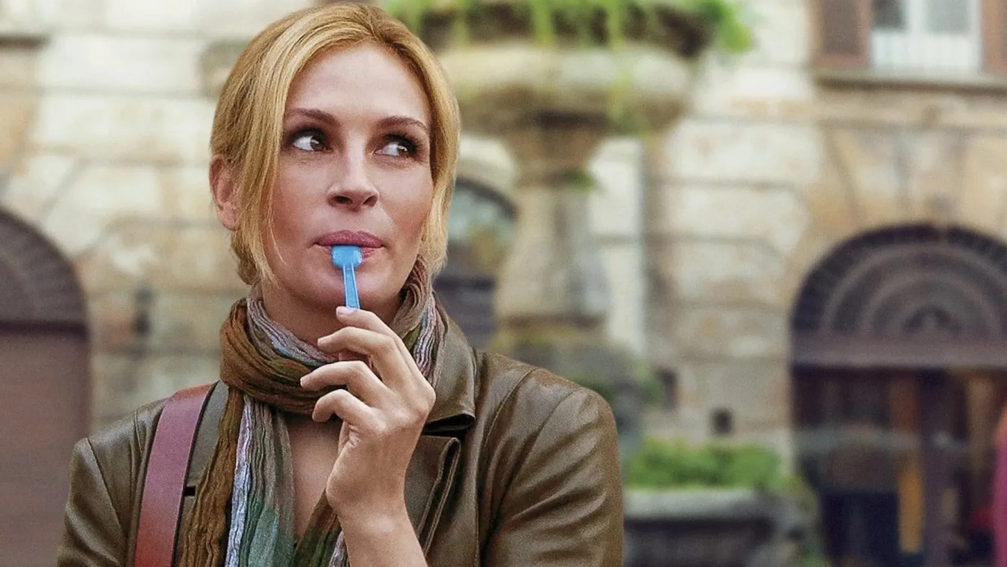 This scene represents one of the moments of pure happiness and enjoyment in the movie, symbolizing the rediscovery of life's simple pleasures during her journey of self-discovery.